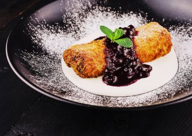 Puff pastry apple strudel with ice cream, served with cherry jam