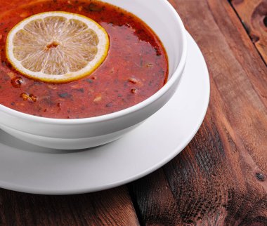 Traditional Ukrainian meat soup Solyanka in bowl