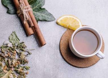 cup of tea with lemon slices and tea packaging