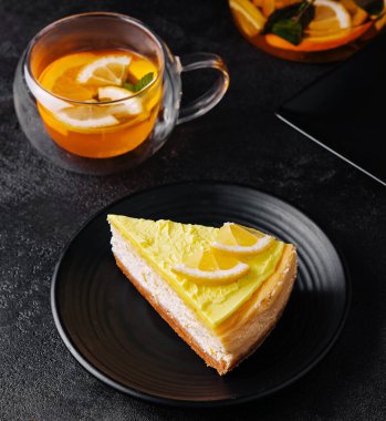 lemon cheesecake with tea glass top view