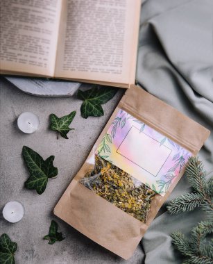 Dried and fresh tea leaves with book