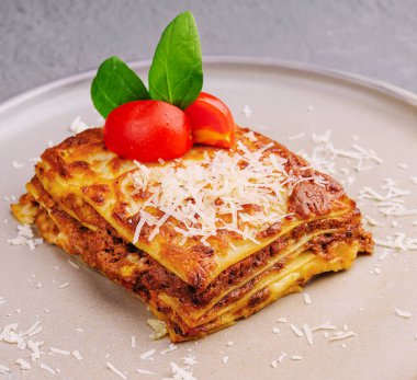 Traditional lasagna with bolognese sauce topped