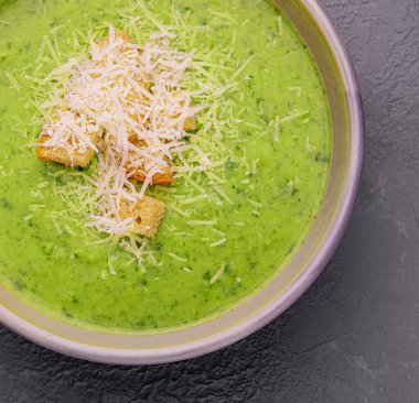 Green vegetable cream soup in bowl