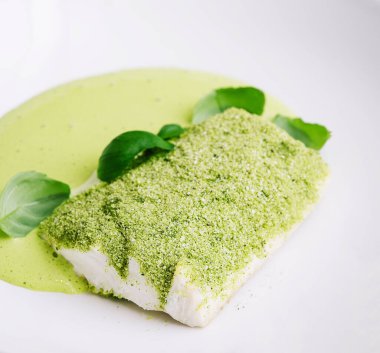 fried fish with basil sauce on plate