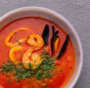 Tom yum soup with shrimp, squid and mussels top view