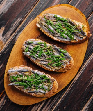 Top view pickled anchovies with spring onions