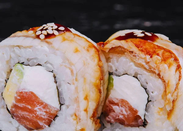 stock image canada roll with salmon on black stone