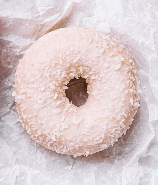 sweet donut with coconut flakes, top view