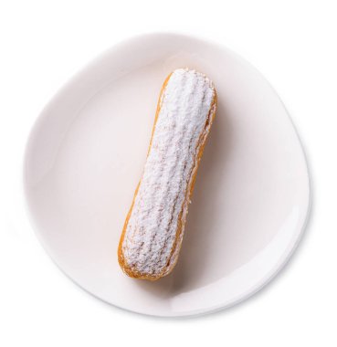 Delicious french dessert Eclair on plate