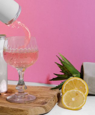 soda in a tin with pink champagne on a pink and white background