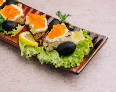 Bruschetta with red caviar on a plate