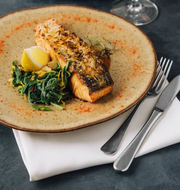 Roasted salmon with wakame seaweed on plate