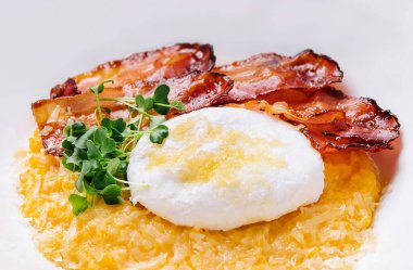 breakfast barley porridge with bacon and a poached egg