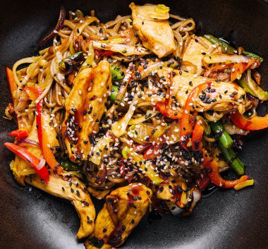 Appetizing asian cuisine chicken and vegetables udon noodles wok