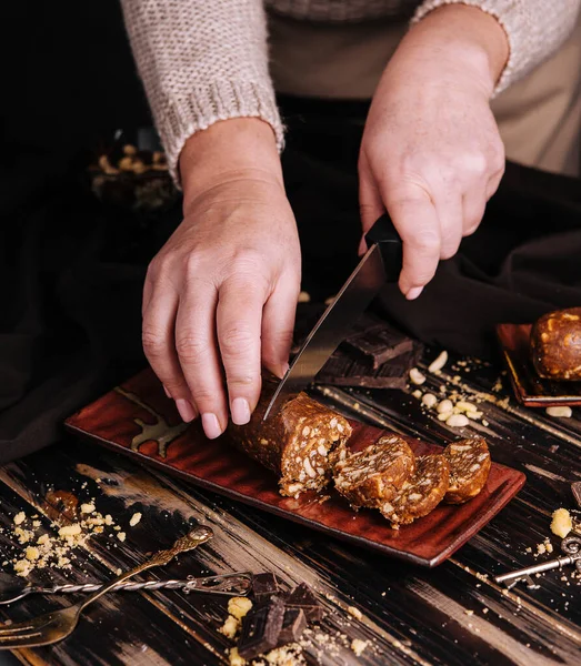 Woman Cuts Chocolate Potato Dessert Knife — Stok fotoğraf