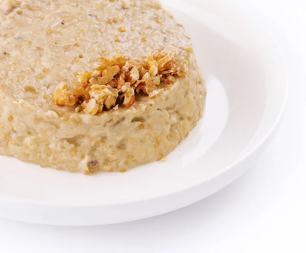 Oatmeal porrige in white plate isolated