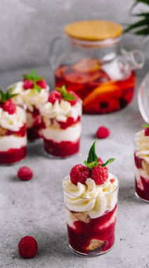 Layered dessert Trifle with vanilla cake, whipped cream and fresh raspberries