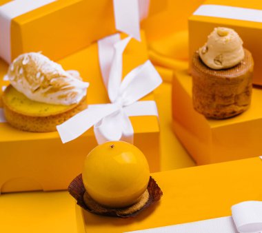different mousses cakes in gift boxes