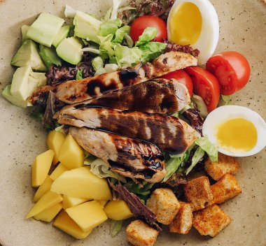 Buddha bowl salad with grilled chicken breast slices