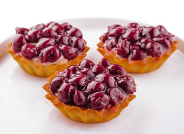 Small tarts with cherries on plate