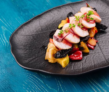 Roasted duck breast with vegetables in fruit sauce