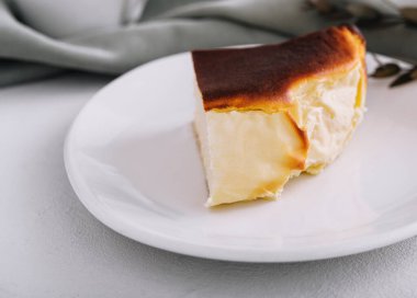 San sebastian cheesecake on plate with tea