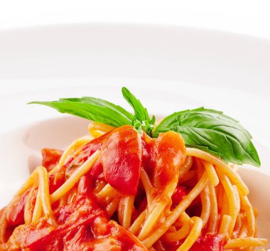Spaghetti with tomato sauce and cherry tomatoes with basil