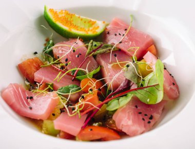 Smoked salmon salad in white bowl close up