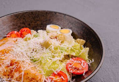 Caesar salad with lettuce, chicken, avocado and croutons