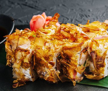 Sushi bonito roll on a dark plate