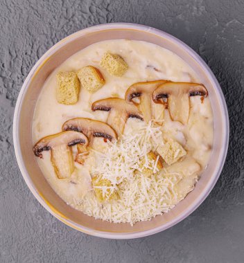 Mushroom cream soup with ingredients on top view