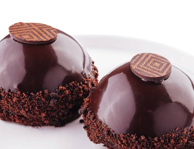 slices of cake in chocolate icing isolated on white