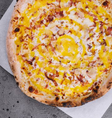 Delicious Italian pizza sliced ham, bacon and cheese