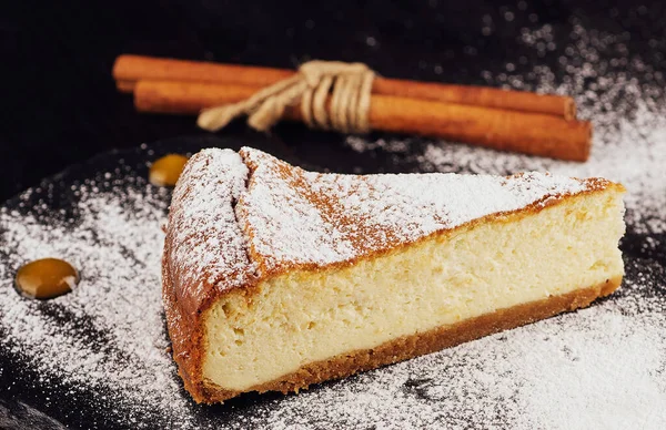 stock image Delicious cheesecake with vanilla on black board