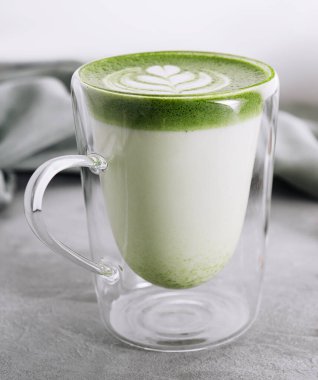 Green matcha latte with pistachios close up