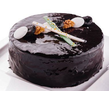 Tasty chocolate cake with prunes and nuts