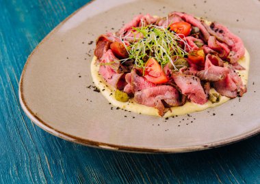 fried cured and sliced veal tongue with mashed potatoes