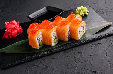 Philadelphia roll sushi with salmon on a dark background