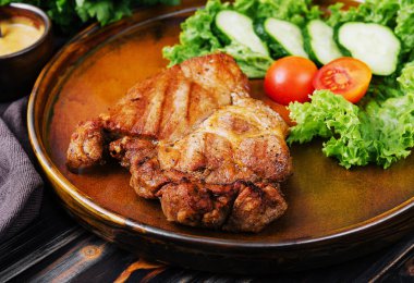 Grilled steaks and vegetables on plate