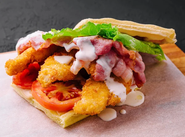 delicious waffle and chicken nuggets on wooden board