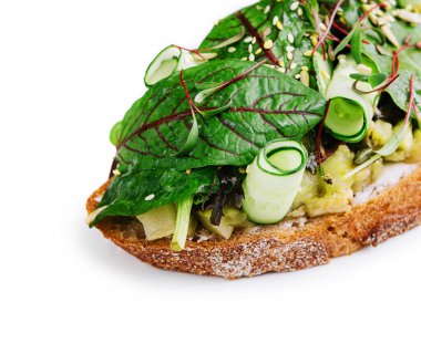 Sandwich with baked eggplant, sliced cucumbers and seeds
