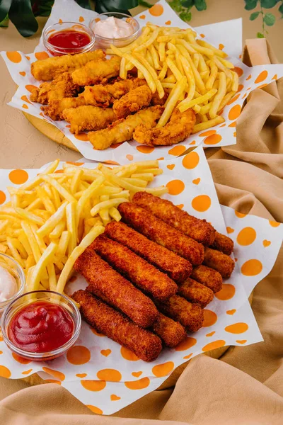 french fries with chicken nuggets and sauces