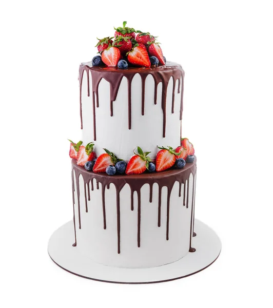 White cake with melted dark chocolate with fresh berries