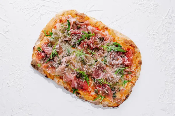 square pizza with prosciutto and arugula