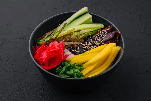 bowl with mango, cucumber and eel in unagi sauce