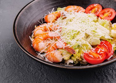 Italian Caesar salad with shrimp in bowl
