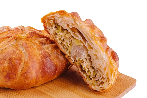 Baking puff pastry with fresh cabbage on wooden