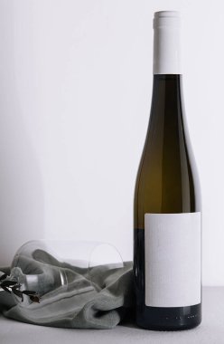 White wine bottle and glass on white