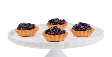 Beyaz büyük tabakta üzümlü küçük kekler.