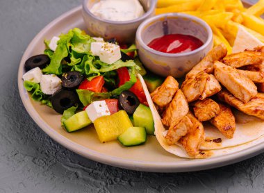 fried chicken breast meat and Greek salad